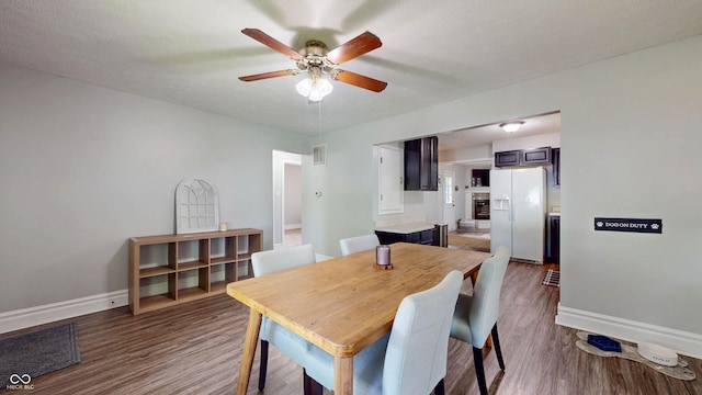 311 S 6th Ave, Beech Grove, IN 46107 - dining space featuring baseboards, ceiling fan, and wood finished floors