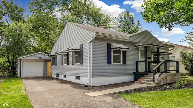 311 S 6th Ave, Beech Grove, IN 46107 - bungalow featuring asphalt driveway, an outbuilding, a garage, a chimney, and a shingled roof