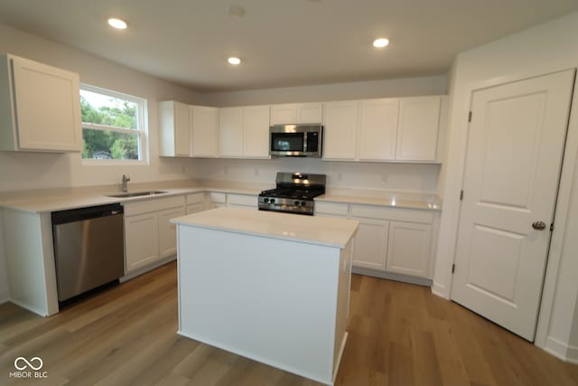 3917 Highcrest Rd, Indianapolis, IN 46239 - kitchen with stainless steel appliances, a sink, white cabinets, light countertops, and recessed lighting