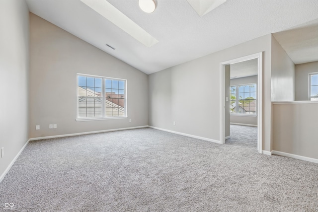 9949 Nightsong Ln, Avon, IN 46123 - spare room featuring carpet flooring, a skylight, lofted ceiling, and baseboards