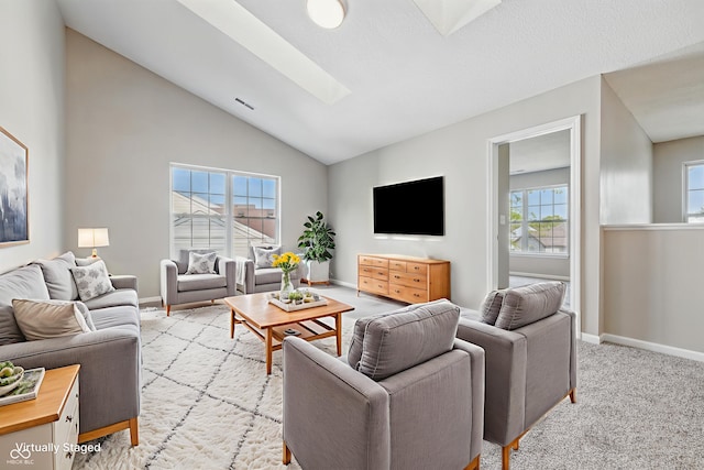 9949 Nightsong Ln, Avon, IN 46123 - living area with a skylight, vaulted ceiling, baseboards, and light carpet