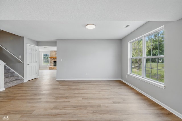 9949 Nightsong Ln, Avon, IN 46123 - empty room with stairway, baseboards, and plenty of natural light