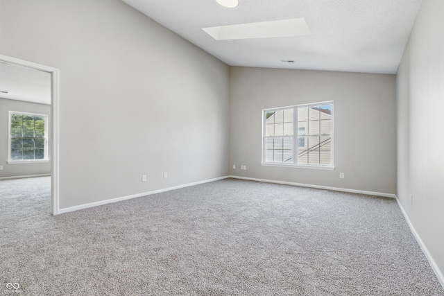 9949 Nightsong Ln, Avon, IN 46123 - empty room with a skylight, lofted ceiling, carpet floors, and baseboards