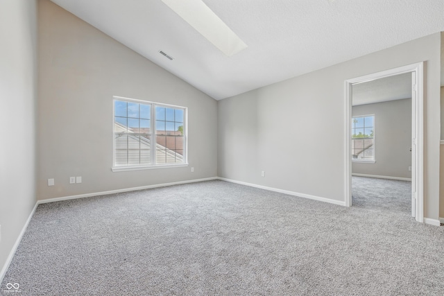 9949 Nightsong Ln, Avon, IN 46123 - carpeted empty room featuring a skylight, vaulted ceiling, and baseboards