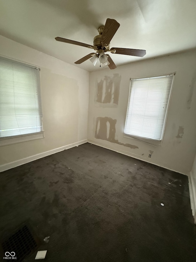 4931 Orion Ave, Indianapolis, IN 46201 - unfurnished room with dark carpet, a ceiling fan, and baseboards