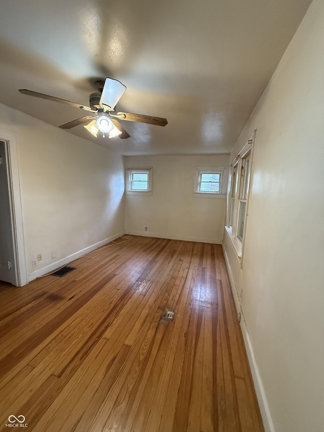4931 Orion Ave, Indianapolis, IN 46201 - spare room with light wood finished floors, a ceiling fan, and baseboards