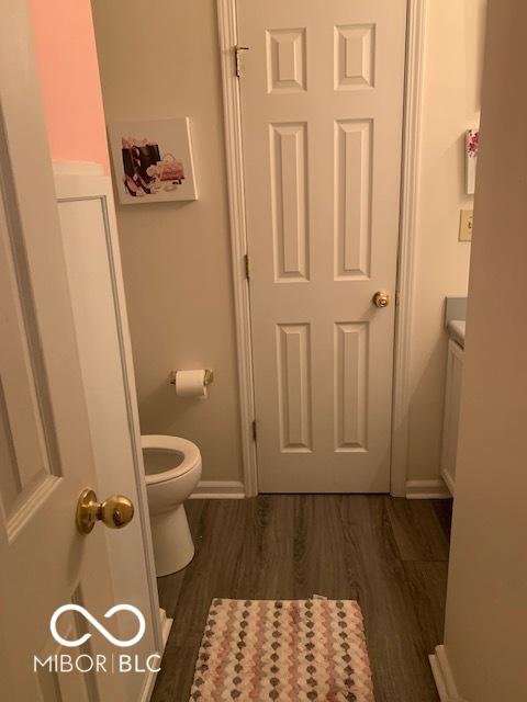 6730 NW Shanghai Cir, Indianapolis, IN 46268 - bathroom featuring toilet and wood finished floors