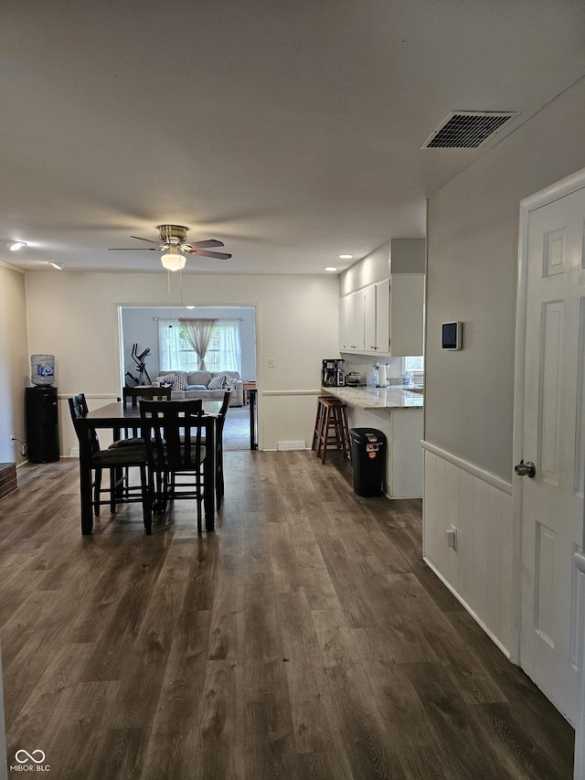 6801 Shalimar Ct, Indianapolis, IN 46214 - dining room featuring ceiling fan, dark wood finished floors, and wainscoting