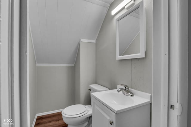 4708 Haverford Ave, Indianapolis, IN 46205 - bathroom with vaulted ceiling, vanity, and wood finished floors