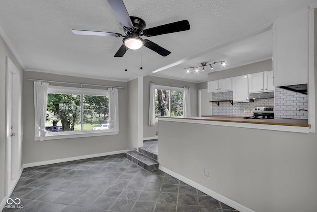 4708 Haverford Ave, Indianapolis, IN 46205 - kitchen featuring stainless steel range with electric stovetop, white cabinetry, decorative backsplash, a ceiling fan, and ornamental molding