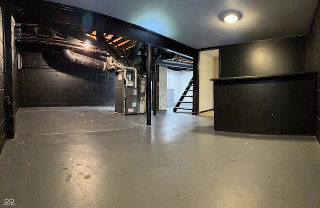 4708 Haverford Ave, Indianapolis, IN 46205 - unfinished basement featuring heating unit, concrete block wall, and stairs