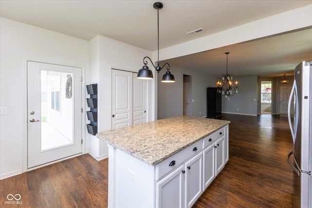 12820 Gloria Dr, Fishers, IN 46037 - kitchen featuring freestanding refrigerator, dark wood-style floors, a chandelier, and white cabinetry