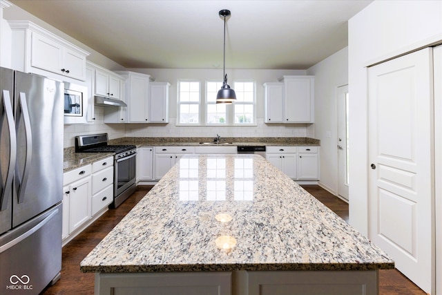12820 Gloria Dr, Fishers, IN 46037 - kitchen featuring appliances with stainless steel finishes, decorative backsplash, a center island, and white cabinetry