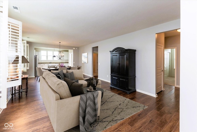 12820 Gloria Dr, Fishers, IN 46037 - living room with a chandelier and dark wood-style flooring