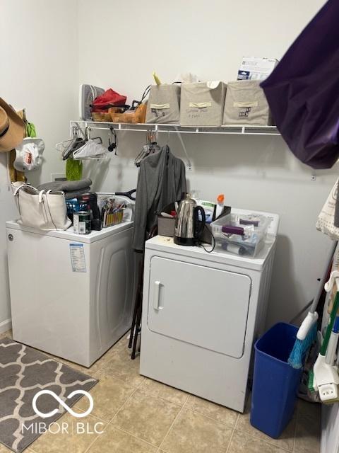 5304 Appleseed Way, Indianapolis, IN 46217 - washroom featuring washing machine and clothes dryer and light tile patterned floors