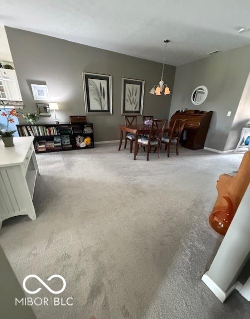 5304 Appleseed Way, Indianapolis, IN 46217 - living room featuring carpet, a chandelier, and baseboards