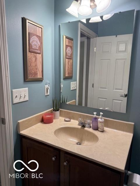 5304 Appleseed Way, Indianapolis, IN 46217 - bathroom featuring vanity and a chandelier
