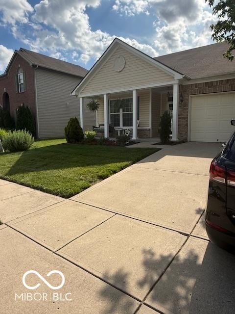 5304 Appleseed Way, Indianapolis, IN 46217 - view of front of property featuring brick siding, driveway, a porch, and a front lawn