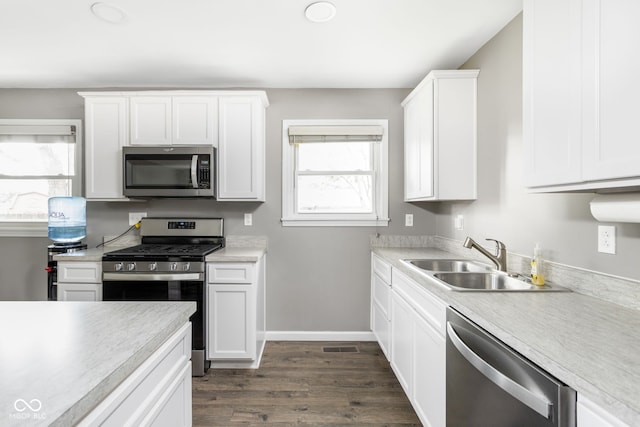 258 N Green Springs Rd, Indianapolis, IN 46214 - kitchen with appliances with stainless steel finishes, a sink, plenty of natural light, and dark wood finished floors