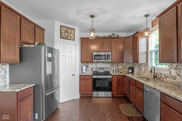 2211 Willowview Dr, Indianapolis, IN 46239 - kitchen featuring appliances with stainless steel finishes, dark wood finished floors, tasteful backsplash, and hanging light fixtures