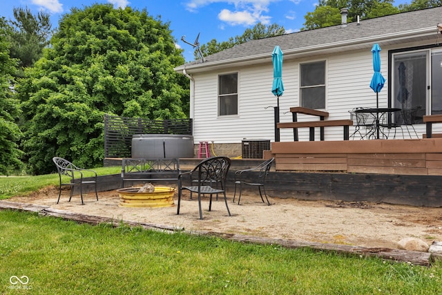 527 E 125 S, Williamsport, IN 47993 - rear view of house with a fire pit, a hot tub, and roof with shingles