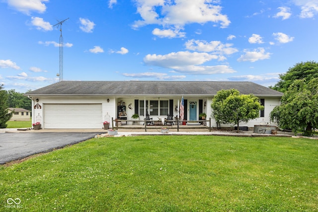 527 E 125 S, Williamsport, IN 47993 - ranch-style home featuring covered porch, asphalt driveway, a garage, and a front lawn