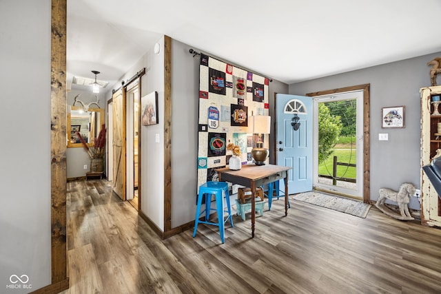 527 E 125 S, Williamsport, IN 47993 - entrance foyer featuring a barn door, wood finished floors, and baseboards