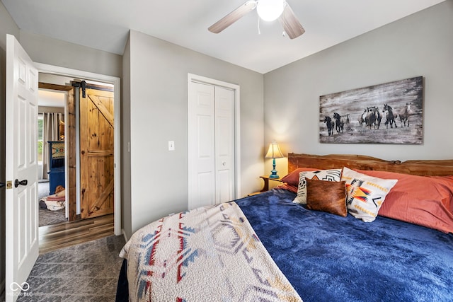 527 E 125 S, Williamsport, IN 47993 - bedroom with a barn door, a closet, ceiling fan, and wood finished floors