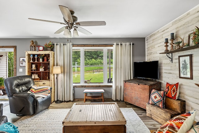 527 E 125 S, Williamsport, IN 47993 - living area featuring a ceiling fan, wood finished floors, and wood walls