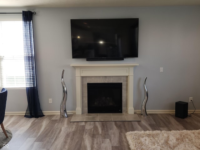 6731 Keepsake Dr, Whitestown, IN 46075 - detailed view of wood finished floors, baseboards, and a tile fireplace