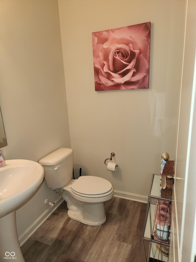 6731 Keepsake Dr, Whitestown, IN 46075 - bathroom featuring wood finished floors, toilet, and baseboards