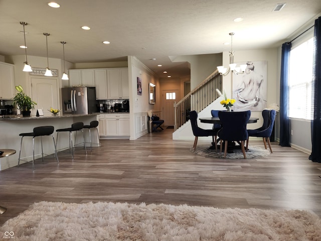 6731 Keepsake Dr, Whitestown, IN 46075 - dining area with a chandelier, recessed lighting, wood finished floors, stairway, and baseboards