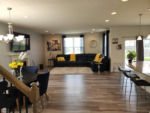 6731 Keepsake Dr, Whitestown, IN 46075 - living room featuring wood finished floors, recessed lighting, a chandelier, and a textured ceiling