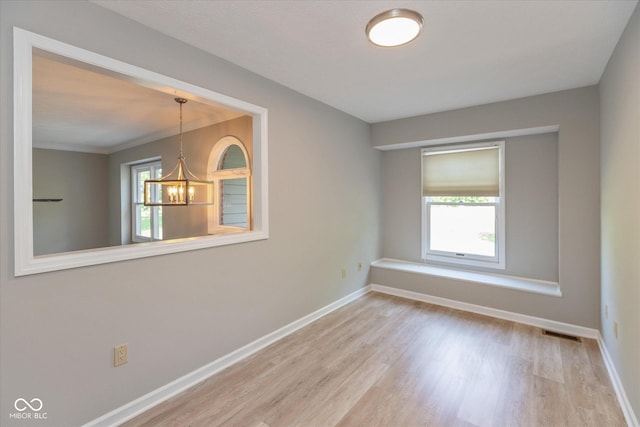 8955 Stonegate Rd Unit A, Indianapolis, IN 46227 - spare room with plenty of natural light, wood finished floors, and a chandelier