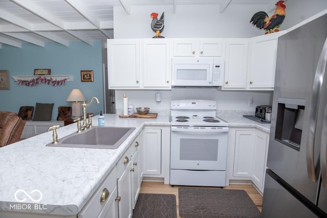 2640 E County Road 600 S, North Vernon, IN 47265 - kitchen featuring white appliances, a sink, white cabinets, a peninsula, and beam ceiling