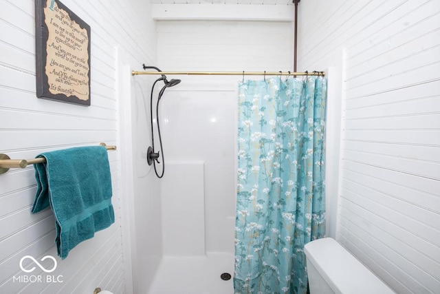 2640 E County Road 600 S, North Vernon, IN 47265 - bathroom with a shower with curtain, wooden walls, and toilet