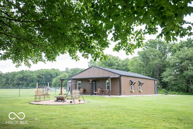 2640 E County Road 600 S, North Vernon, IN 47265 - back of property featuring an outdoor fire pit and a view of trees