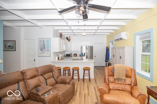 2640 E County Road 600 S, North Vernon, IN 47265 - living room featuring light wood-style floors, a wall mounted AC, a ceiling fan, and beam ceiling