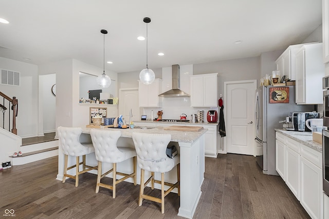 15598 Memorial Way, Fishers, IN 46037 - kitchen featuring wall chimney range hood, dark wood finished floors, freestanding refrigerator, white cabinetry, and recessed lighting