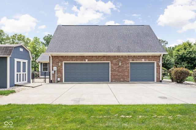 5695 N Red Oak Dr, Greenfield, IN 46140 - view of front facade with brick siding, roof with shingles, a gate, concrete driveway, and a storage unit