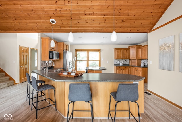 5695 N Red Oak Dr, Greenfield, IN 46140 - kitchen featuring stainless steel appliances, a peninsula, wooden ceiling, decorative backsplash, and light wood-type flooring