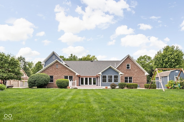5695 N Red Oak Dr, Greenfield, IN 46140 - back of house with brick siding, a storage unit, a lawn, and a patio area