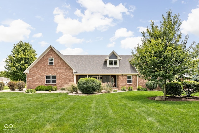 5695 N Red Oak Dr, Greenfield, IN 46140 - view of front of home featuring brick siding, a front yard, and roof with shingles