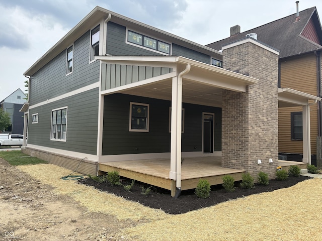 2148 N Pennsylvania St, Indianapolis, IN 46202 - back of property featuring covered porch, a chimney, and brick siding