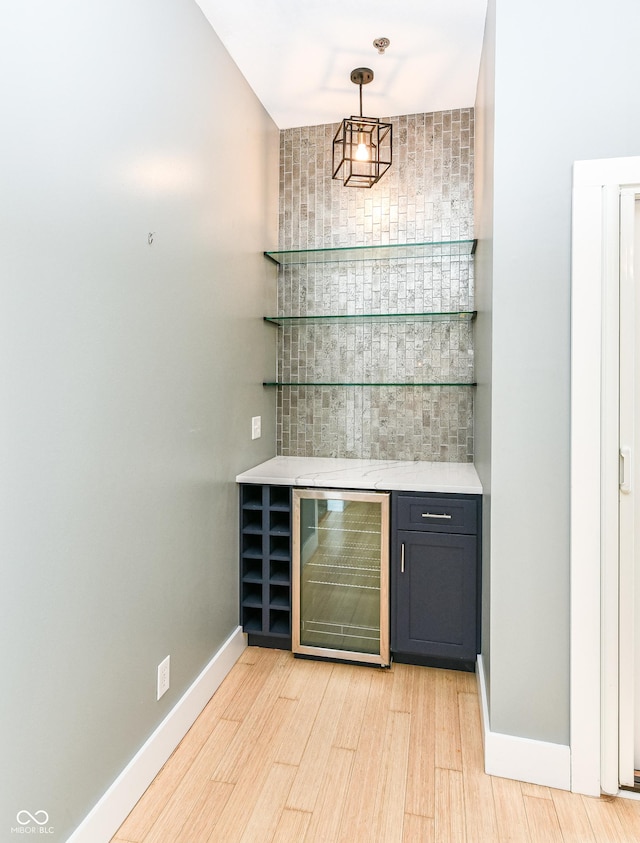 721 E N St Unit 2C, Indianapolis, IN 46202 - indoor dry bar with beverage cooler, light wood-style floors, and pendant lighting