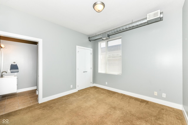 721 E N St Unit 2C, Indianapolis, IN 46202 - unfurnished bedroom featuring carpet flooring and a closet
