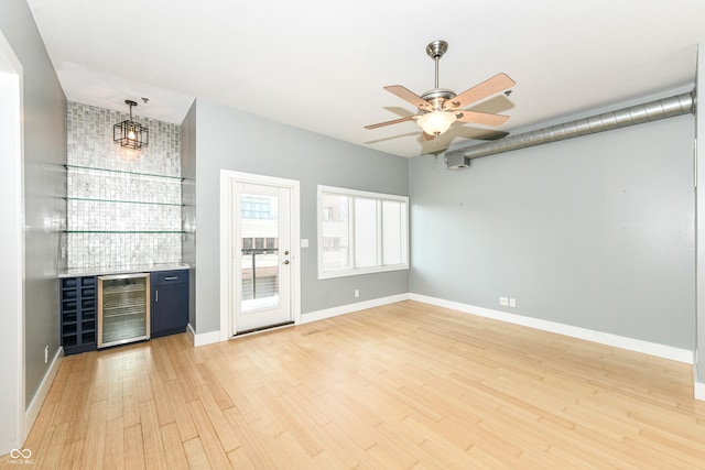 721 E N St Unit 2C, Indianapolis, IN 46202 - indoor dry bar featuring beverage cooler, light wood-style flooring, and a ceiling fan