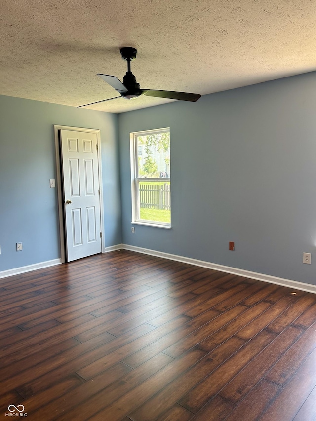 12307 Chiseled Stone Dr, Fishers, IN 46037 - unfurnished bedroom featuring a textured ceiling, dark wood finished floors, baseboards, and ceiling fan