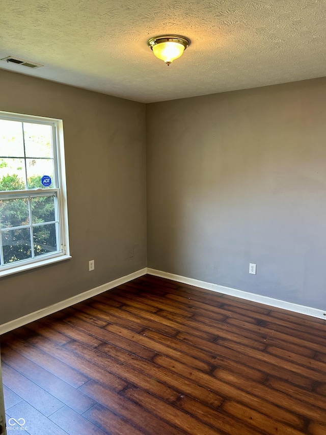 12307 Chiseled Stone Dr, Fishers, IN 46037 - empty room featuring dark wood finished floors, baseboards, and a textured ceiling