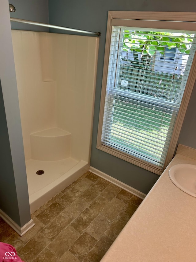 12307 Chiseled Stone Dr, Fishers, IN 46037 - full bathroom with baseboards, plenty of natural light, a shower, and a sink
